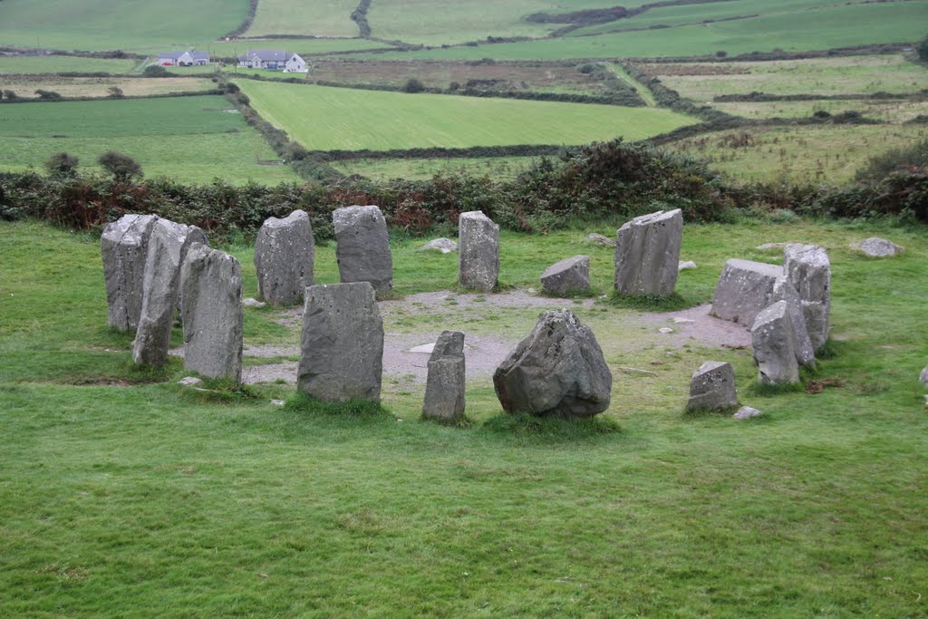 Drombeg Stone Circle, At the winter (21st December), the sun sets at a point on the horzont aligned with the axiel stone and portal stone. On the upper surface of of the axid stone are two shallow depresions, one surrounded by an oval carving , Co. Cork, 